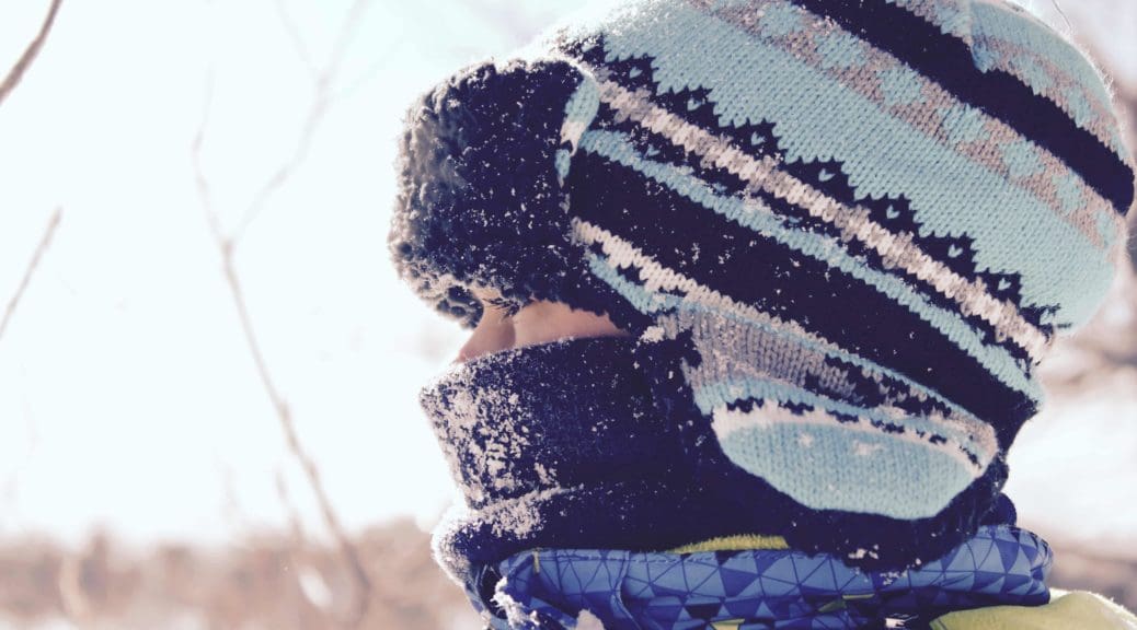 Child wearing hat in the snow