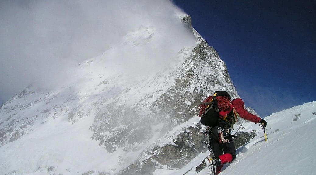 An expert mountain climber on a snowy Alpine peak