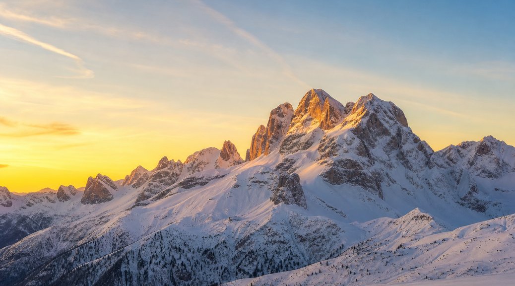Snow-covered Alpine mountains at sunrise