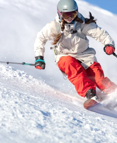 Woman skier going down the mountain