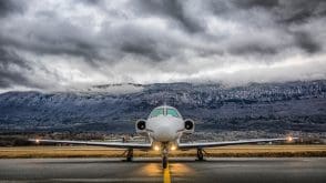 Private plane on runway, with clouds in the background