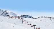 A long distance view of a cable car against white slopes in Sölden - Transfers