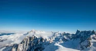 Snowy mountain peaks under a blue sky in the Alps