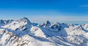 White mountains in the Alps under a blue sky