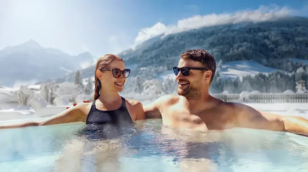 A couple in a hot tub at a ski spa