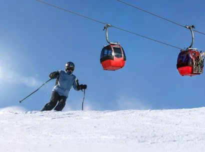 A skier by a cable car